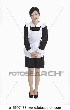 Young waitress standing with hands folded in front View Large Photo Image Stock Photo - Young waitress standing with hands folded in front. Fotosearch