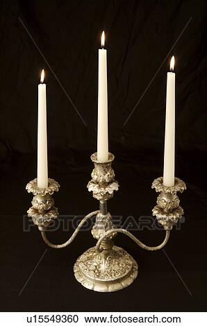 Stock Image - Candlestick Holder in black background. Fotosearch
