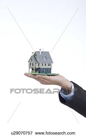Stock Photo - House in a hand. Fotosearch