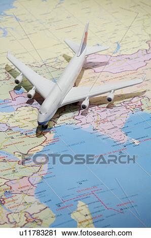 Stock Image - Model Airplane on a world map. Fotosearch