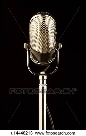 Stock Image - Old-fashioned microphone in black background. Fotosearch
