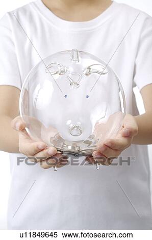 Stock Photography - Piggy Bank held in someone's hand. Fotosearch