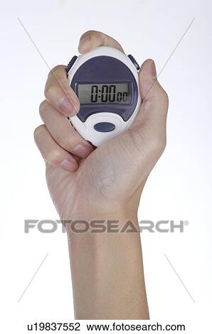 Stock Image - Stopwatch held in hand. Fotosearch