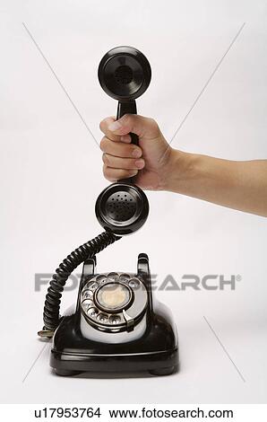 Picture - Telephone held in hand. Fotosearch