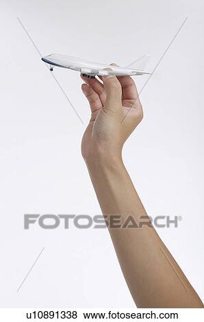 Stock Photo - Toy airplane in hand. Fotosearch