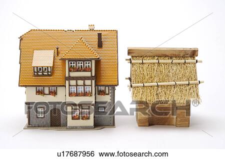 Toy villa vs. thatched-roof hut View Large Photo Image Stock Photograph - Toy villa vs. thatched-roof hut. Fotosearch