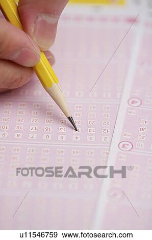 Stock Photo - Writing with pencil on a lottery lot. Fotosearch