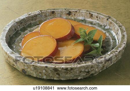 Stock Image - Sweet Potato Boiled With Orange Sauce. Fotosearch