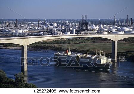 Stock Photography - Cargo Ship in Houston Ship Channel Passing Under Bridge. Fotosearch