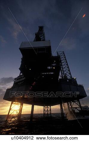 Stock Image - Close-up View of Offshore Oil Drilling Rig at Sunset. Fotosearch