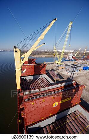 Crane Offloading Pipe from Cargo Ship View Large Photo Image Stock Photo - Crane Offloading Pipe from Cargo Ship . Fotosearch