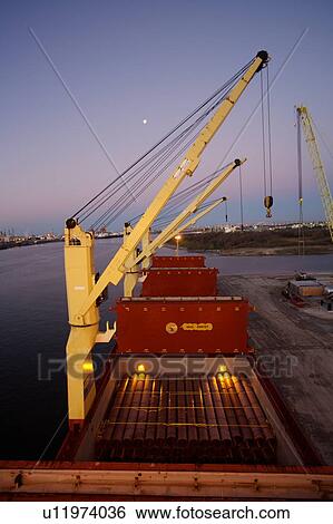 Crane Offloading Pipe from Cargo Ship View Large Photo Image Stock Photograph - Crane Offloading Pipe from Cargo Ship . Fotosearch