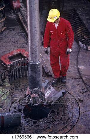 Drilling Rig Worker Setting Slips on Drill Pipe View Large Photo Image Stock Image - Drilling Rig Worker Setting Slips on Drill Pipe. Fotosearch