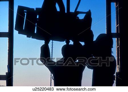 Stock Image - Drilling Rig Workers Positioning Equipment. Fotosearch