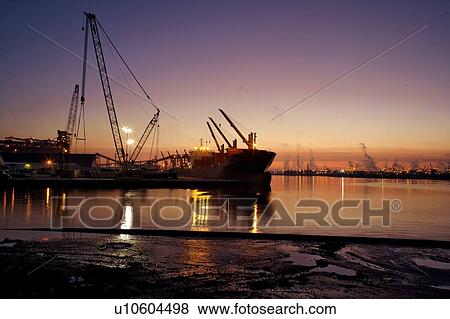 Stock Photo - Offloading Cargo from Cargo Ship. Fotosearch