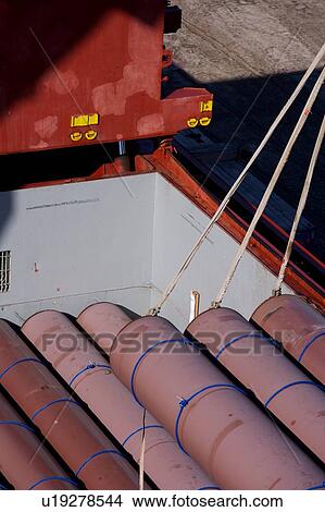 Picture - Offloading Pipe from Cargo Ship. Fotosearch