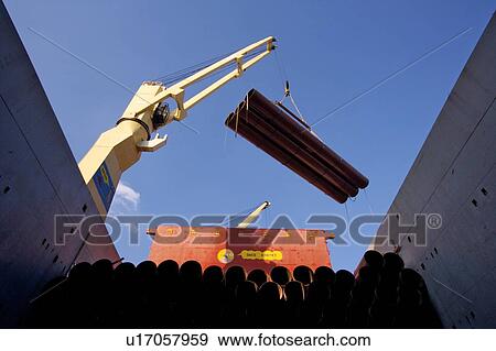 Stock Photo - Offloading Pipe from Cargo Ship. Fotosearch