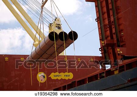 Stock Photo - Offloading Pipe from Cargo Ship. Fotosearch