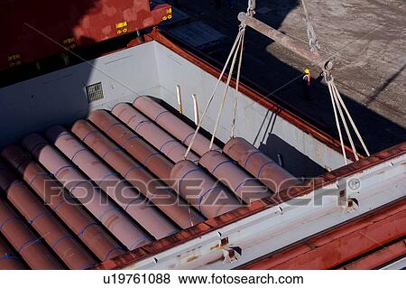 Stock Photo - Offloading Pipe from Cargo Ship. Fotosearch