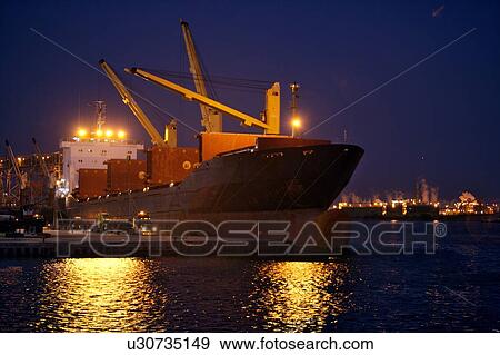 Offloading Pipe from Cargo Ship to Truck at Night View Large Photo Image Stock Photo - Offloading Pipe from Cargo Ship to Truck at Night. Fotosearch