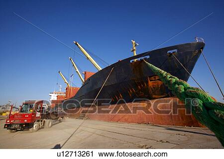 Offloading Pipe from Cargo Ship to Truck View Large Photo Image Stock Image - Offloading Pipe from Cargo Ship to Truck. Fotosearch