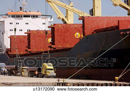 Offloading Pipe from Cargo Ship to Truck View Large Photo Image Stock Image - Offloading Pipe from Cargo Ship to Truck. Fotosearch