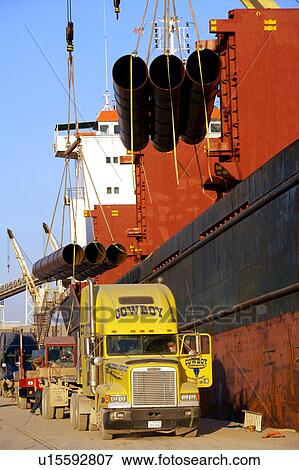 Offloading Pipe from Cargo Ship to Truck View Large Photo Image Stock Photo - Offloading Pipe from Cargo Ship to Truck. Fotosearch