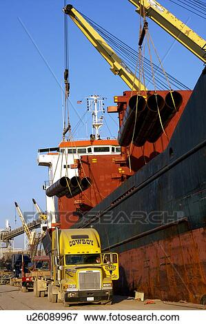 Offloading Pipe from Cargo Ship to Truck View Large Photo Image Stock Photo - Offloading Pipe from Cargo Ship to Truck. Fotosearch