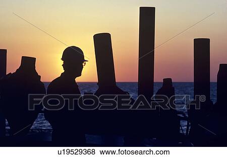 Stock Photo - Offshore Drilling Rig Worker Inspecting Drilling Equipment. Fotosearch