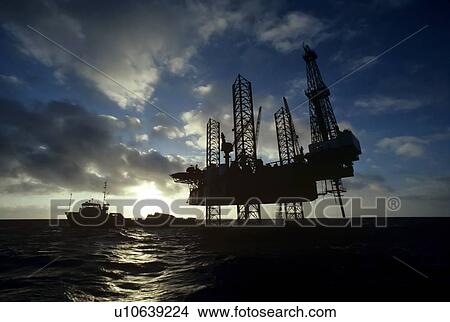 Picture - Offshore Oil Drilling Rig and Supply Boat. Fotosearch