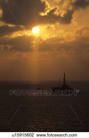 Stock Image - Offshore Oil Drilling Rig at Sunset. Fotosearch