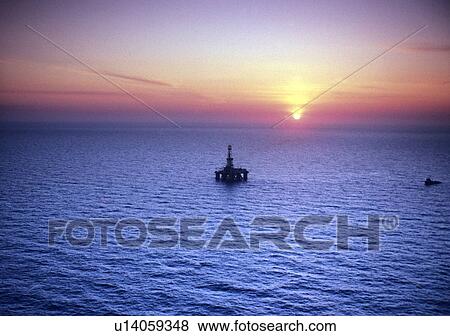 Offshore Oil Drilling Rig at Sunset View Large Photo Image Stock Photo - Offshore Oil Drilling Rig at Sunset. Fotosearch