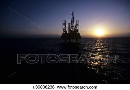 Stock Photograph - Offshore Oil Drilling Rig at Sunset. Fotosearch