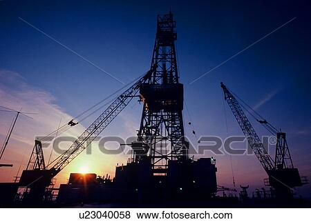 Stock Photo - Offshore Oil Drilling Rig Derrick at Sunset. Fotosearch