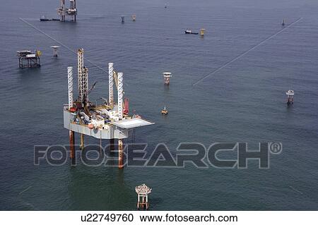 Stock Image - Offshore Oil Drilling Rig with Oil Field Structures. Fotosearch