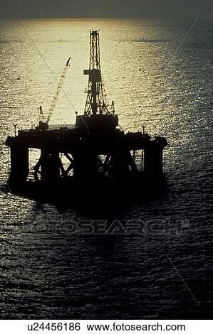 Stock Photograph - Offshore Oil Drilling Rig with Moonlight Reflection. Fotosearch