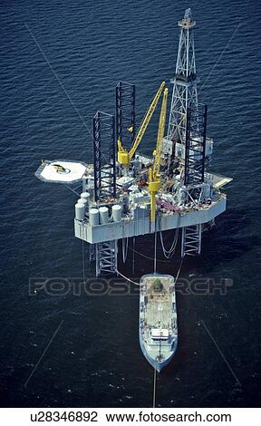 Offshore Oil Drilling Rig with Supply Boat Offloading View Large Photo Image Stock Image - Offshore Oil Drilling Rig with Supply Boat Offloading. Fotosearch