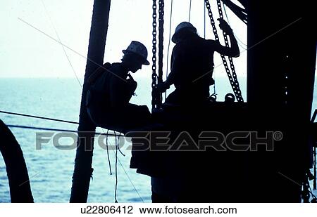 Stock Image - Offshore Oil Rig Workers in Derrick. Fotosearch