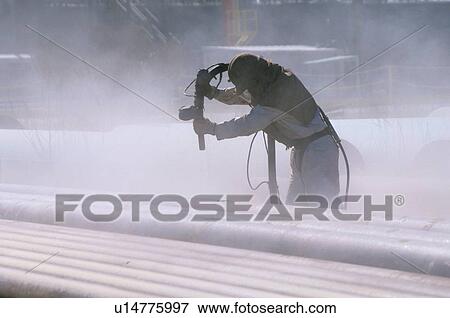 Oil Facility Worker Cleaning Pipe View Large Photo Image Stock Photo - Oil Facility Worker Cleaning Pipe. Fotosearch