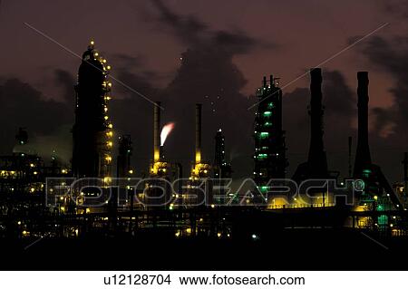 Picture - Oil Refinery with Flare Stack Burning Waste Gas at Night. Fotosearch