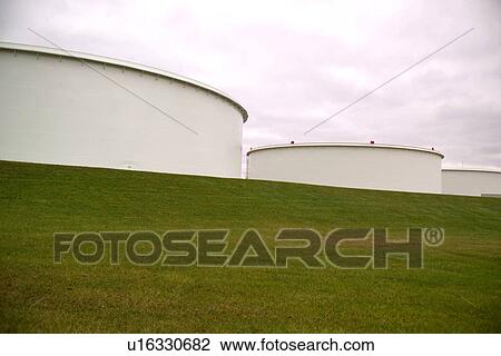 Stock Image - Oil Storage Tanks on Hillside. Fotosearch