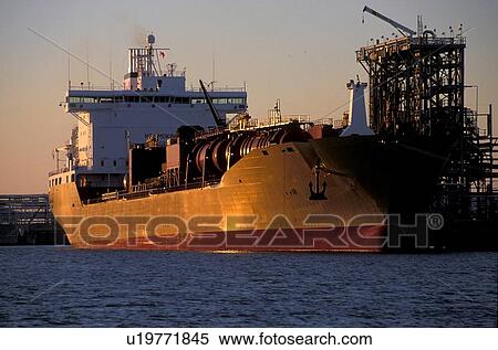 Stock Photography - Oil Tanker Offloading in Houston Ship Channel at Sunset. Fotosearch