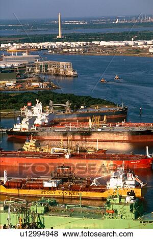 Stock Photo - Oil Tankers in Houston Ship Channel with San Jacinto Monument in Background. Fotosearch