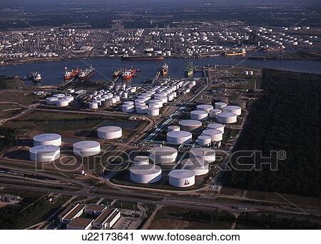 Stock Image - Oil Tankers Offloading at Oil Storage Facility. Fotosearch