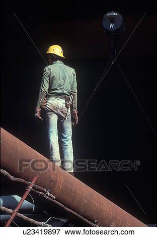 Stock Photo - Oilfield Worker by Pipeline. Fotosearch