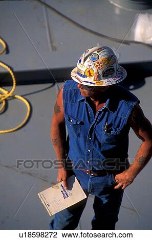 Stock Image - Oilfield Worker with Paperwork. Fotosearch