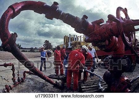 Stock Image - Oilfield Workers, Wellhead Assembly Maintenance. Fotosearch