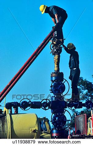 Stock Photo - Oilfield Workers, Wellhead Assembly Maintenance. Fotosearch