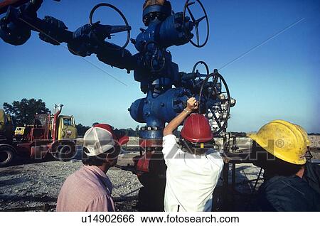Stock Photograph - Oilfield Workers, Wellhead Assembly Maintenance. Fotosearch