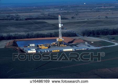 Onshore Oil Drilling Rig in Farmland View Large Photo Image Stock Photo - Onshore Oil Drilling Rig in Farmland. Fotosearch